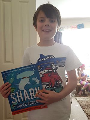 Alfie Gordon with Shark Super Powers book
